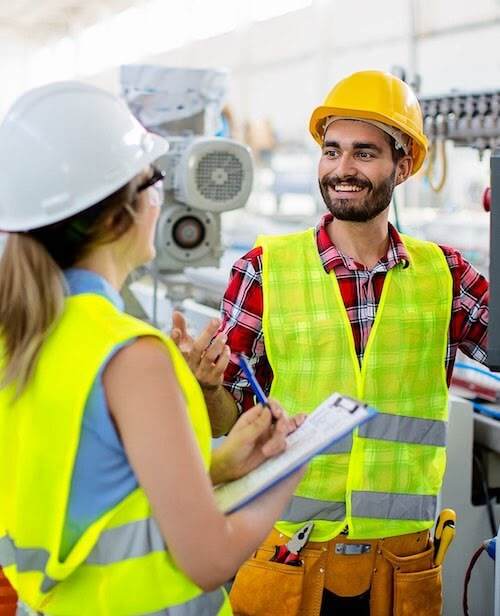 Factory floor employees reviewing checklist