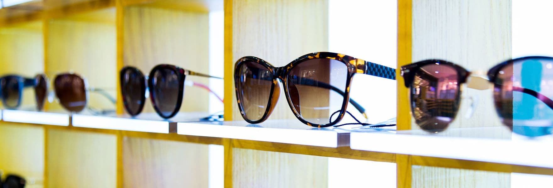 Sunglasses displayed in backlit shelf